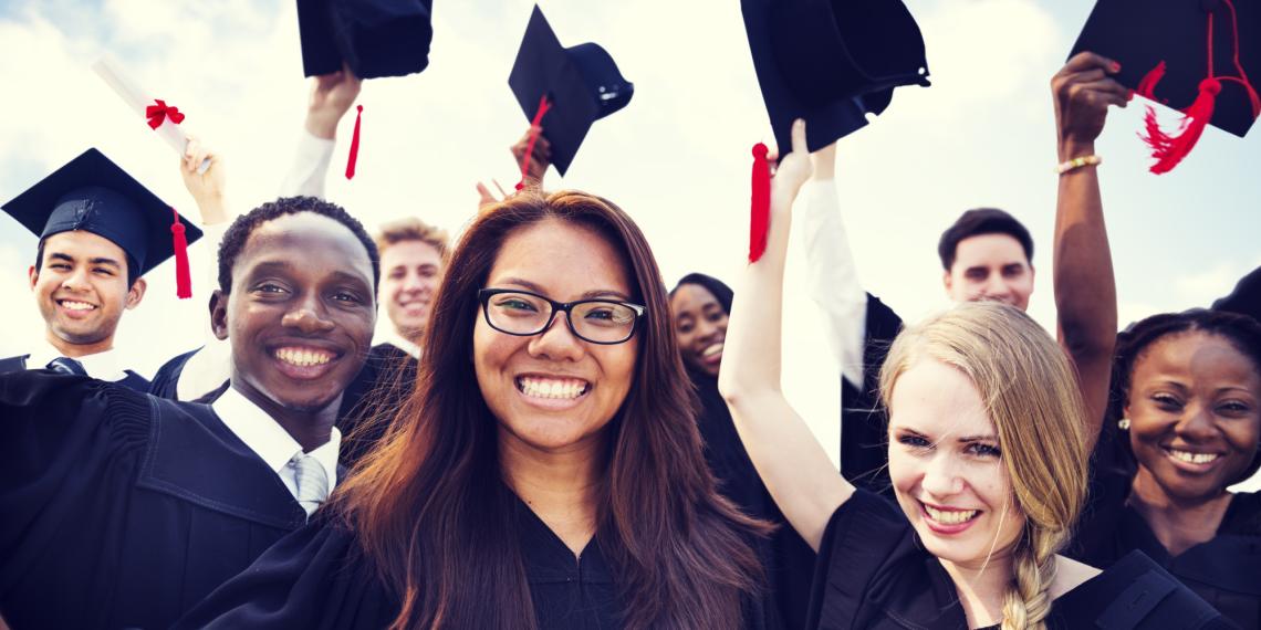 Smiling students in graduation gowns